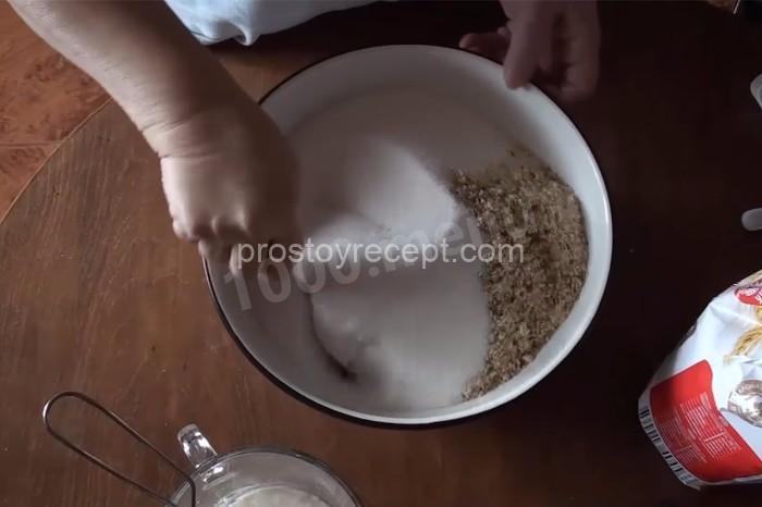 Смешайте грецкие орехи с сахаром. Параллельно растопите сливочное масло и